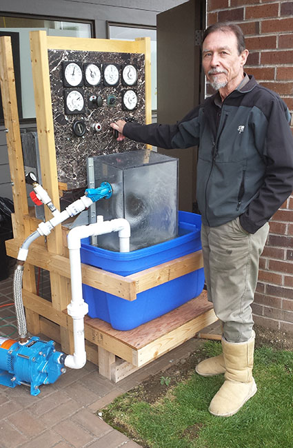 Mead with a scale-model hydroelectric power plant he built for educational use.